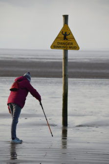 Person standing on muddy beach at Weston Super Mare